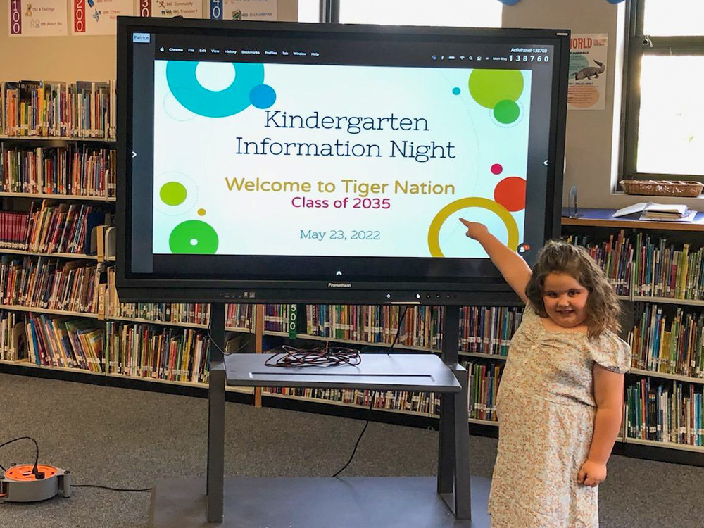 kinder student pointing at presentation
