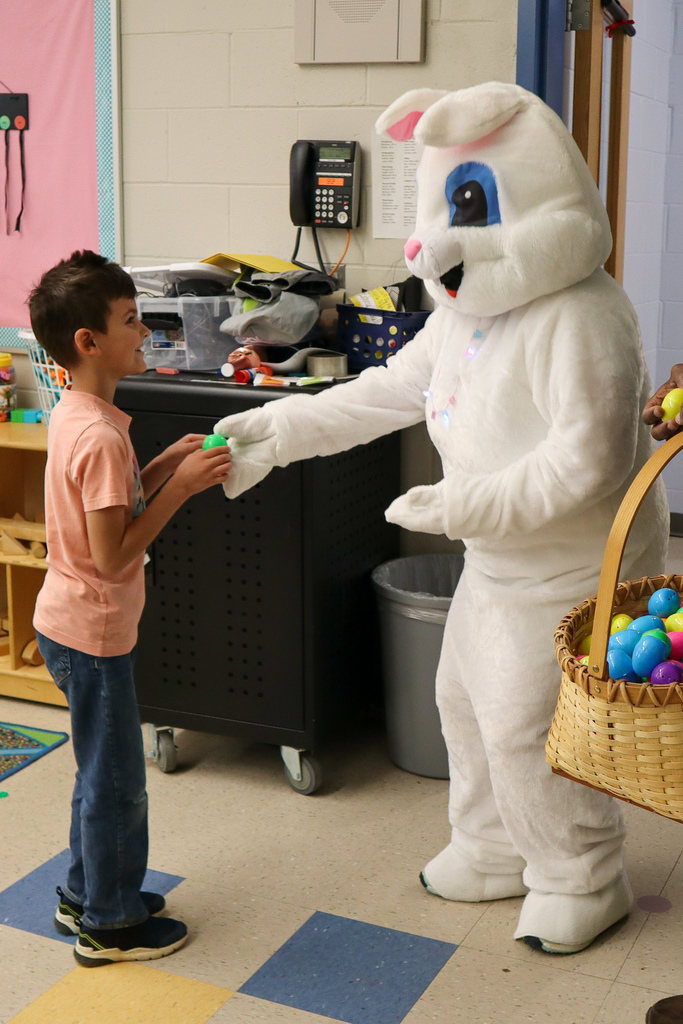 student getting egg from easter bunny