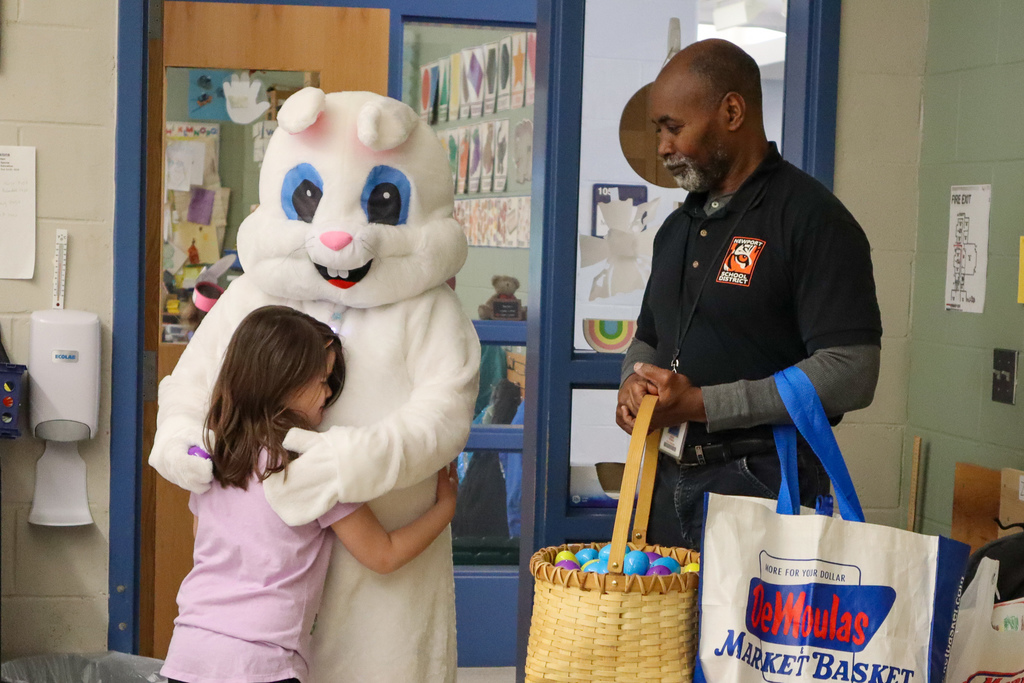 Easter bunny hugging student