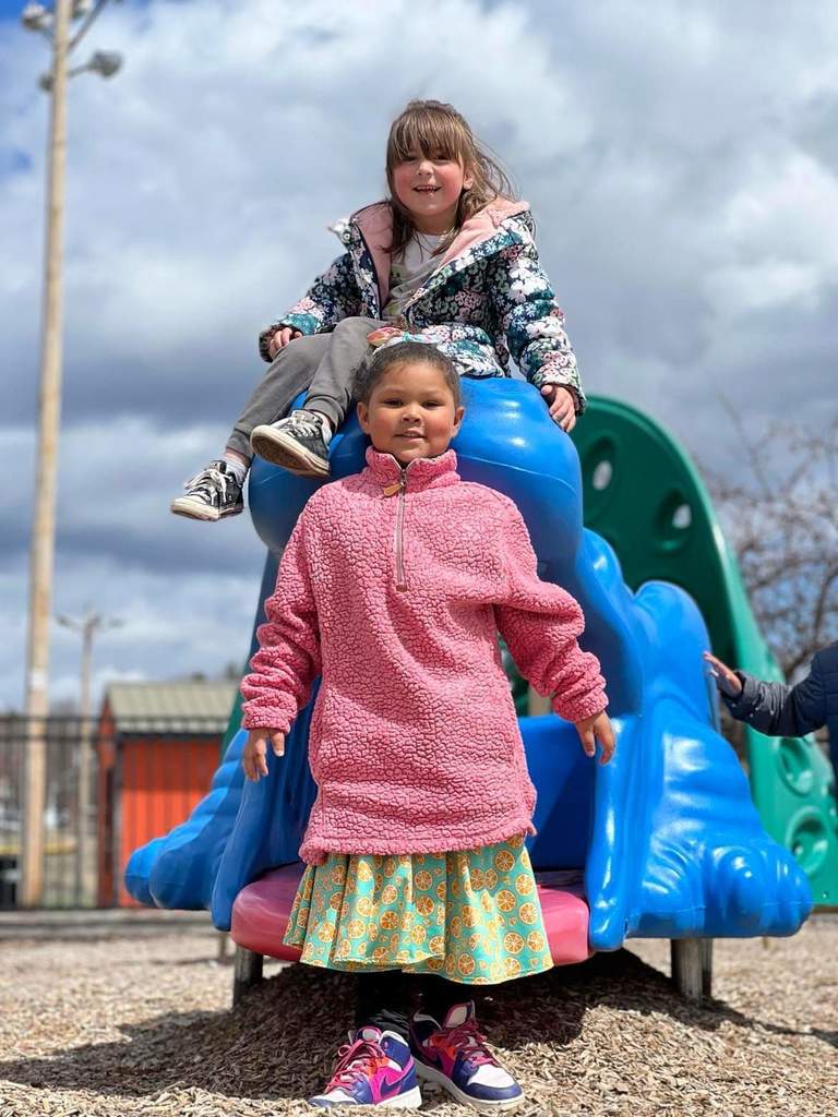 Two girls playing on playground 