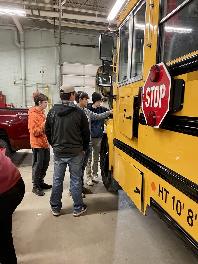 Students looking at a bus